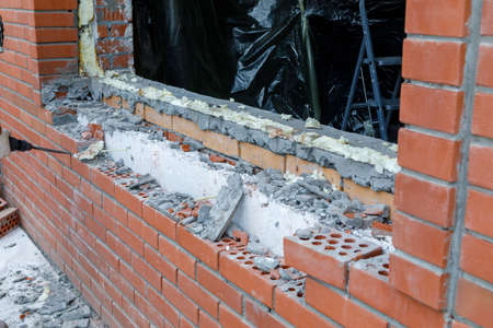 Gypsum plaster is applied to a brick wall. Plastered brick wall in the apartment