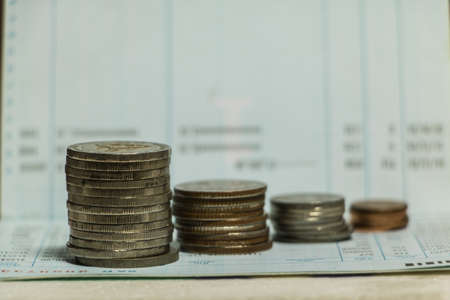 Coin on Savings deposit  Passbook  by blur backgrounds.の写真素材