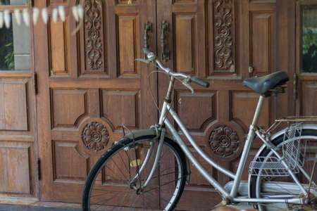A Old bicycle before door.の写真素材