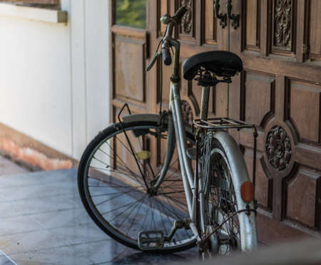 A Old bicycle before door.の写真素材