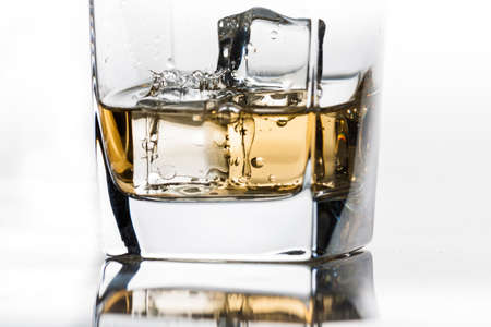 Single drop in whiskey on the rocksの写真素材
