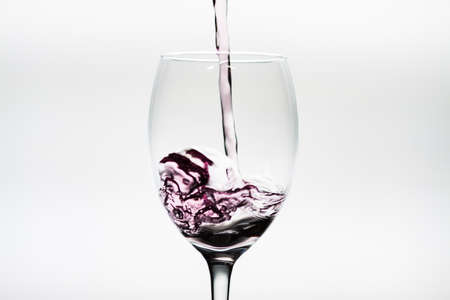 Splash of wine inside a wineglassの写真素材