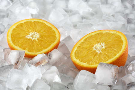 Orange halves between ice cubesの写真素材