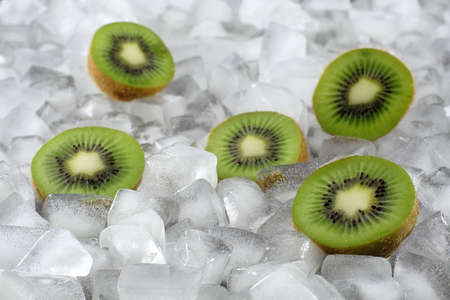Kiwi halves between ice cubesの写真素材