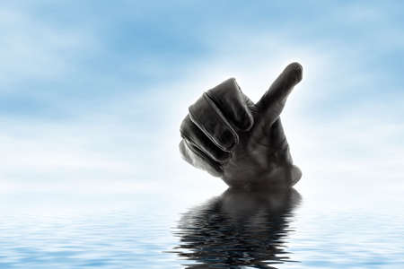 Thumb up gesturing gloveの写真素材