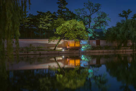 Gyeongbokgung Palace At Night In South Korea, with the name of the palace 'Gyeongbokgung' on a signのeditorial素材