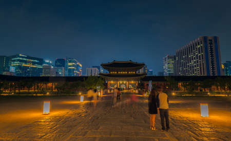 Gyeongbokgung Palace At Night In South Korea, with the name of the palace 'Gyeongbokgung' on a signのeditorial素材