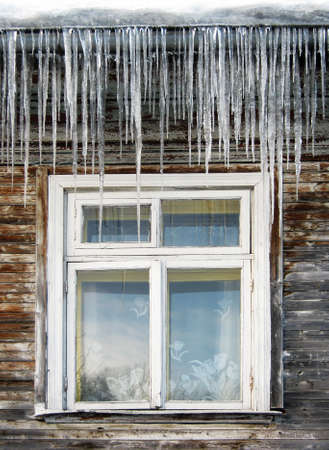 Icicles on wooden houseの写真素材