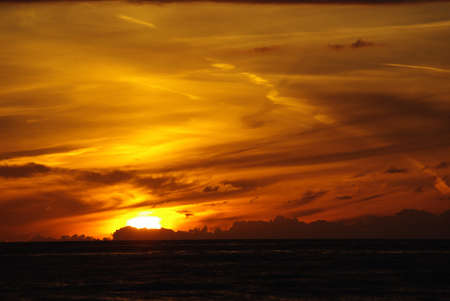 Sea sunset with lighted cloudsの写真素材