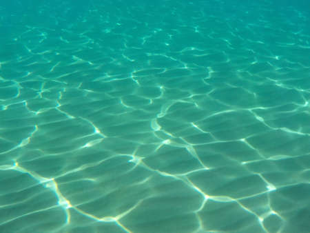 Clear blue water with sun glare in Mediterranean Seaの写真素材