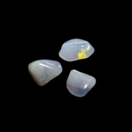 Three tumbling chalcedony stones on black backgroundの写真素材