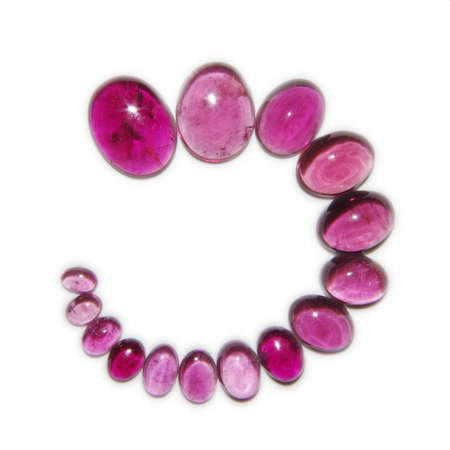 Many different size pink tourmaline cabochons on white backgroundの写真素材