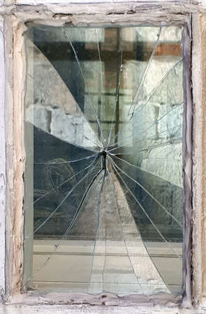Broken window in an old house, reflections in pieces of glass