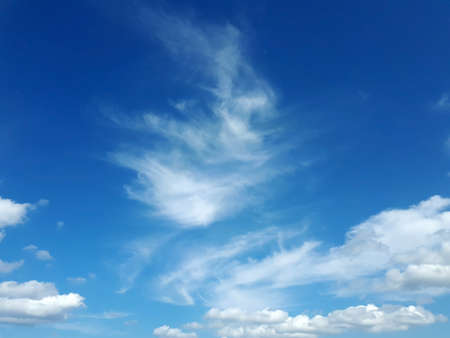 Blue sky with fluffy white clouds, can be used as backgroundの写真素材