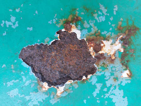 Texture of old metal surface, peeling green paint, rust showing through paint