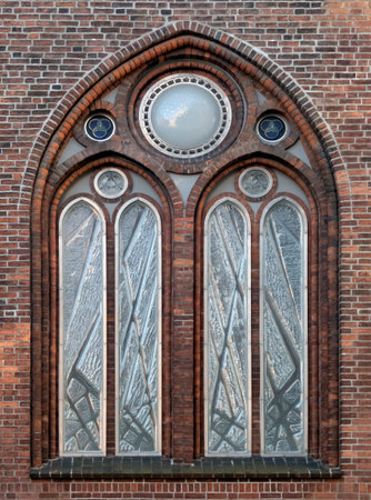 Beautiful large arched window in the brick wall of the Dome Cathedral in Riga, Latvia, Europe.の写真素材