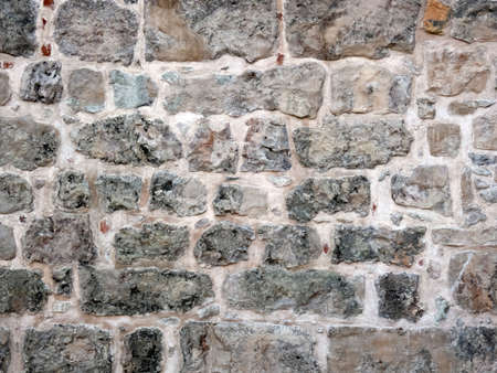 Fragment of ancient house's wall made of different sizes gray stones. Horizontal shot.の写真素材
