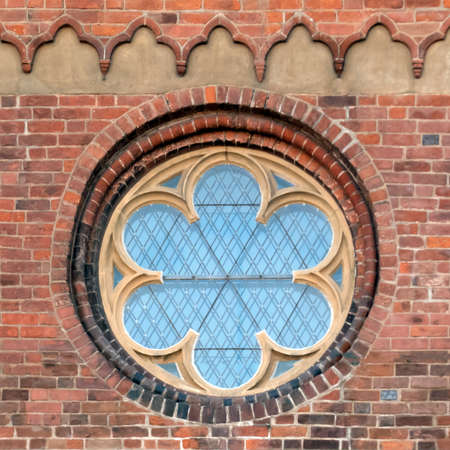 Beautiful large round window in the brick wall of the Dome Cathedral in Riga, Latvia, Europe.の写真素材