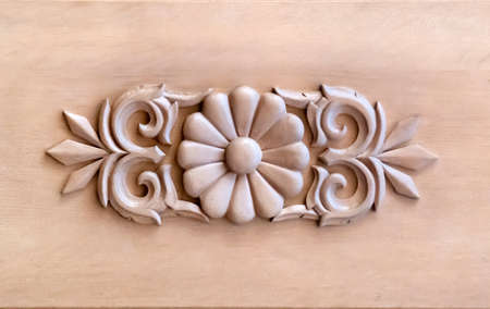 Brown wood carved panel with beautiful floral pattern. Nice element for your design. Horizontal shot.の写真素材