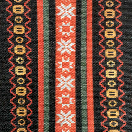 Latvian national patterns on woolen fabric. Repeating symbols. Auseklis. Square shot.の写真素材