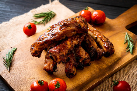 grilled barbecue ribs pork with rosemary and tomatoesの写真素材