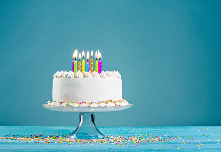 White birthday cake over blue backgroundの写真素材