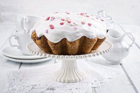 Easter cake with white icing on a white wooden background. Selective focus.の写真素材