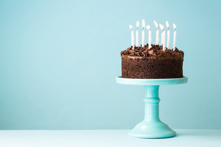Birthday cake with candles on blue background. Shallow depth of fieldの写真素材