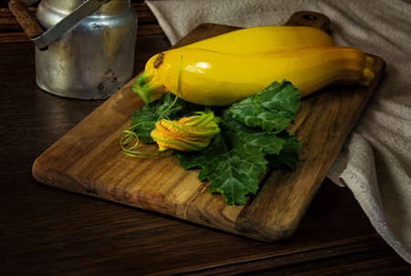 Yellow zucchini on the wooden board - still lifeの写真素材
