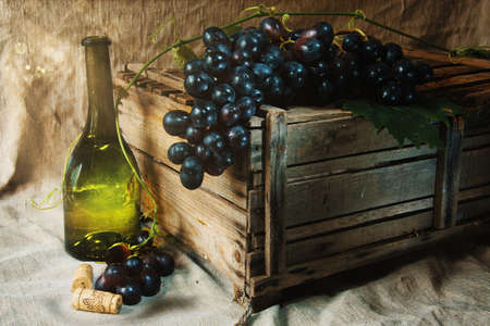 Blue wine grapes on the broken wooden boxの写真素材