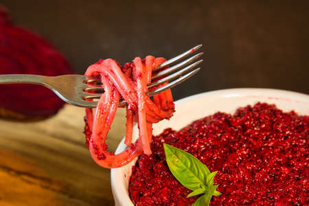 Beetroot pesto with spaghetti on the forkの写真素材