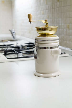 Coffe grinder near gas stove on kitchenの写真素材