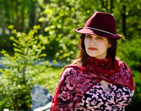 Women in bordo hat on the parkの写真素材