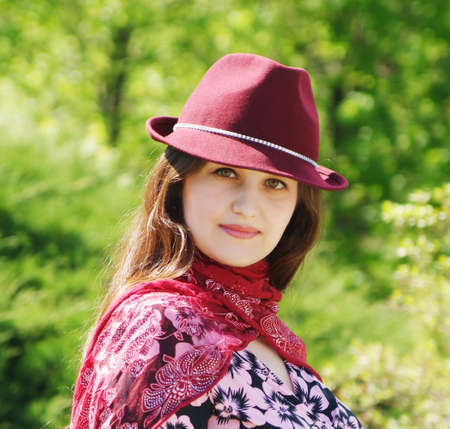 Women in bordo hat on the parkの写真素材