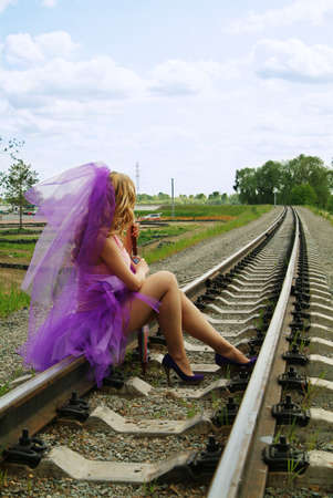 beauty girl sitting on the rail. Suicide.の写真素材