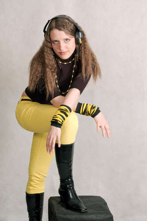 Curly woman with headphone in the studioの写真素材