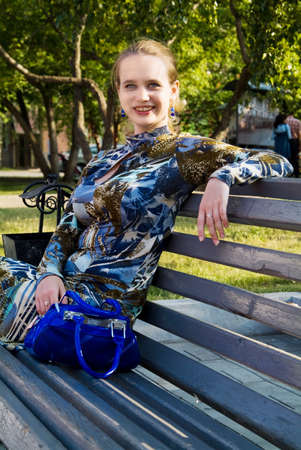 Portret of the young woman on the branch in the parkの写真素材