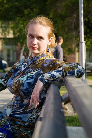 Portret of the young woman on the branch in the parkの写真素材