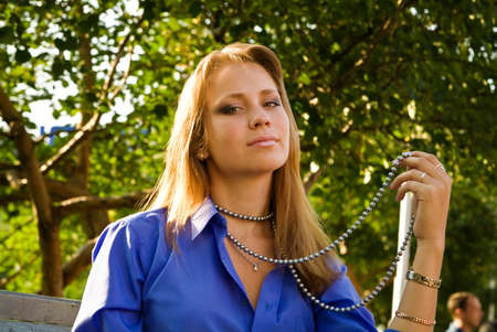 Portret of the woman with beads in the parkの写真素材