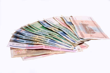 The roll of money of Belarusian rubles lies a fan on a table isolate white background の写真素材
