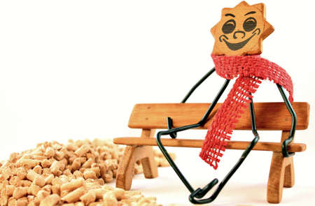 Close-up of a figure on a wooden bench with wood pelletsの写真素材