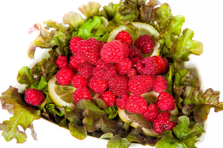 Sweet raspberry with a green salad and lemonの写真素材