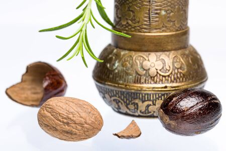 Bio nutmeg with grinder and rosemaryの写真素材