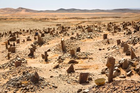 Berber old cemetery at abandoned mining village on edge of the Sahara desert in Morocco.の写真素材