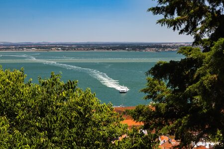 Aerial view of red roofs of Alfama and the River Tagus, Lisbon, Portugal. Lisbon is colorful, friendly and very attractive.のeditorial素材