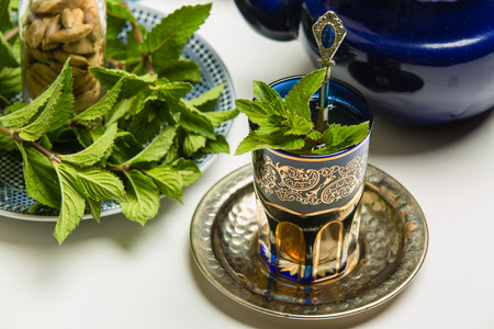 Traditional Arab mint tea in a traditional cup with mint leavesの写真素材
