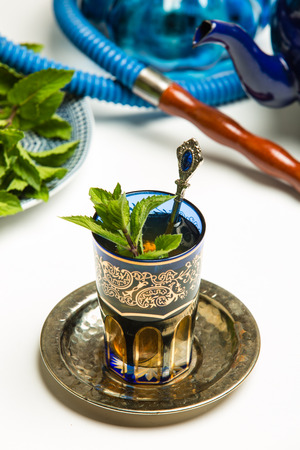 Traditional Arab mint tea in a traditional cup with mint leavesの写真素材
