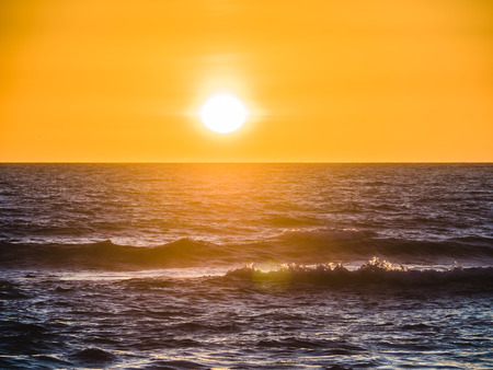 Sunset over the Atlantic on the beach at Gale on the southern Portuguese coast of the Atlantic.の写真素材