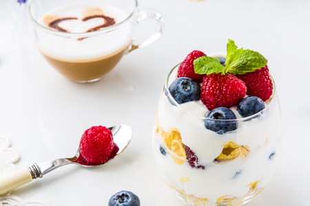 Healthy breakfast full of vitamins and probiotics. Yoghurt, cornflakes and fruit.の写真素材