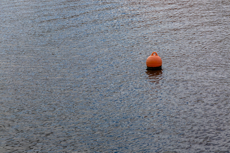 Buoy on a quiet waterfront in the town of Bosa in Sardiniaの写真素材